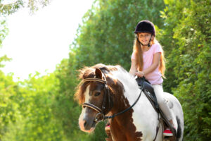 child riding horse